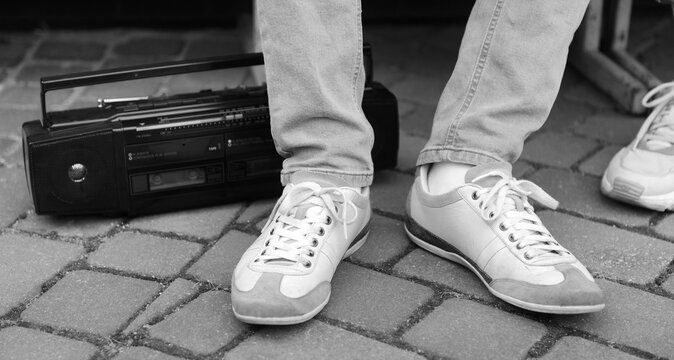 Enjoying music on the street with a boombox and sneakers