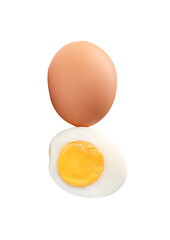 Front view of raw brown chicken eggs and cooked or boiled chicken egg with egg yolk in half in stack isolated with clipping path in png file format