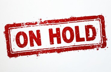 Red stamp on white. Grunge style illustration of the text on hold. Symbol of waiting. Concept of restriction. Isolated design element for announcements.