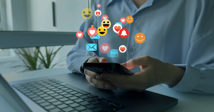 Social media,marketing, like,social network,blog,live,chat reaction and livestream. Woman using smart phone with emoticon icons of Social Media.Interactive with friends on chat with emoticon feedback.
