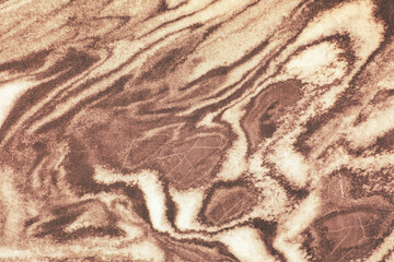 Striking chocolate-brown marble surface with intricate veins and polished texture, creating a luxurious abstract background perfect for creative projects and digital design.