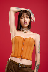Stylish young woman poses confidently with modern fashion in a vibrant studio setting