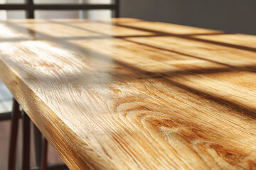 Bright oak table wooden surface sunlight shadow room interior natural grain warm tone empty tabletop closeup texture clean finish modern home