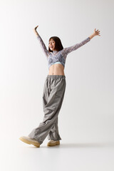 Obraz premium Stylish young woman exudes joy and confidence in contemporary fashion