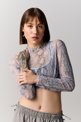 Stylish young woman poses confidently in trendy attire conveying effortless elegance