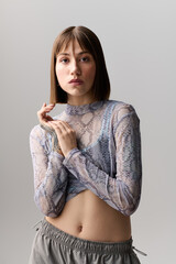 Charming young woman showcases modern fashion in a serene environment