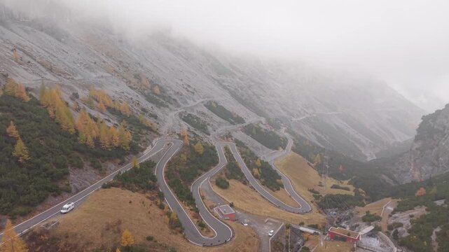 Hairpin turns of Stelvio mountain road in autumn, aerial view.