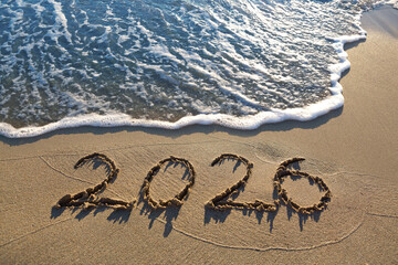 New Year 2026, lettering on the sunny beach sand.
