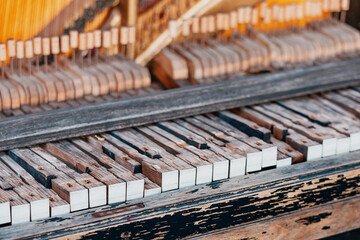Old abandoned piano with broken wooden keys and chipped paint, s