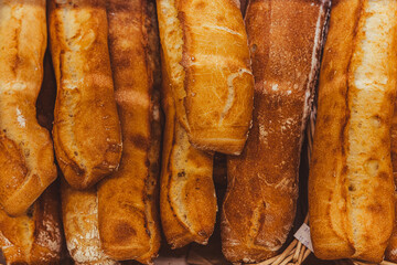 Freshly baked bread with raisins on a wooden stand in the bakery taken off the shelf in the supermarket.