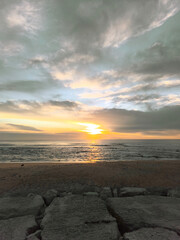 Obraz premium Magic empty beach at dusk. Serene golden sunset seascape with gentle waves and dramatic Sky