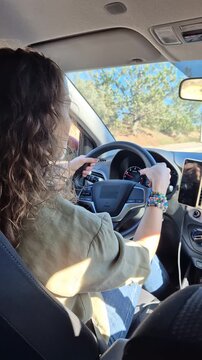 Driving, Road Trip, Woman traveling alone in a modern car on a sunny highway during a relaxing fall journey.