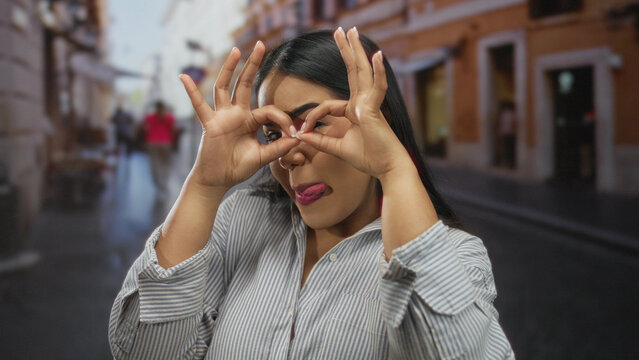Woman playfully posing outdoors on a vibrant street, capturing the lively essence of urban life with a touch of youthful humor and charm.