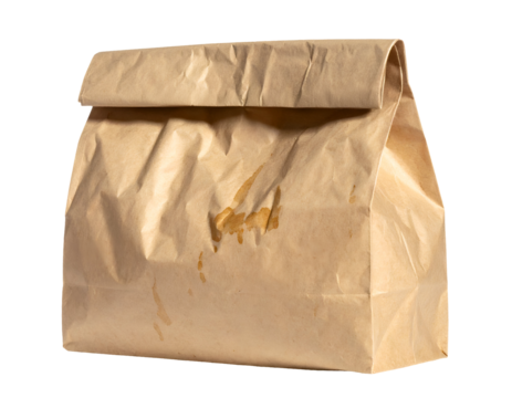 Brown paper lunch bag with grease stains and wrinkled kraft texture standing upright on isolated background