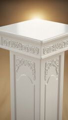 Elegant white pedestal display stand with ornate carvings