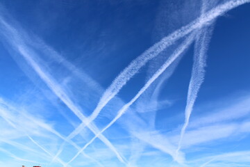 Intersecting Contrails Against a Bright Blue Sky