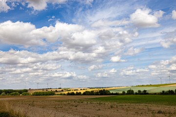 Epernay, Marne, Grand-Est, France, August, 28th, 2025, Champagne Area, Expansive fields beneath luminous skies, Open countryside with shining clouds over cultivated terrain and lush fields