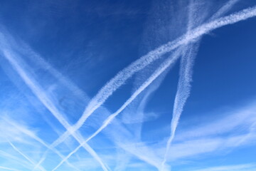 Intersecting Contrails Against a Bright Blue Sky
