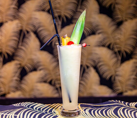 Exotic Pi&ntilde;a Colada or Tropical Creamy Cocktail with Pineapple Leaf Garnish