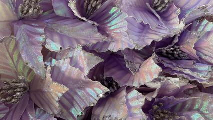 Iridescent purple holiday flower macro. Silver glitter and shimmer festive texture background