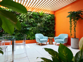 Modern office space with vibrant living wall and comfy armchairs offers a calming retreat for creative collaboration and team meetings today