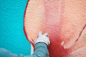 Painting graffiti on the wall. Close up. 