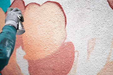 Painting graffiti on the wall. Close up. 