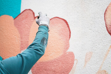 Painting graffiti on the wall. Close up. 