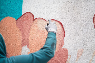 Painting graffiti on the wall. Close up. 