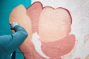 Painting graffiti on the wall. Close up. 