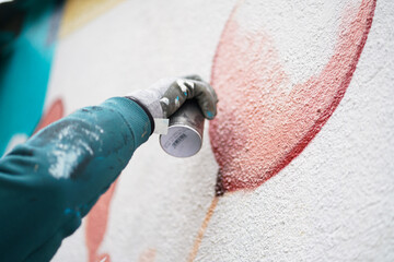 Painting graffiti on the wall. Close up. 