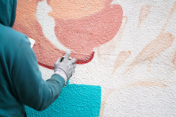 Painting graffiti on the wall. Close up. 