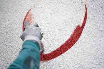Painting graffiti on the wall. Close up. 