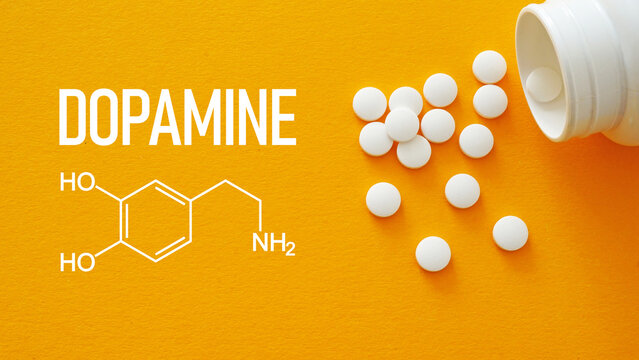 Dopamine hormone drug is shown using the text with pills and Chemical formula