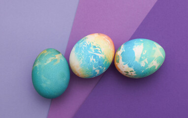 Colored Easter eggs on purple background
