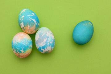 Colored Easter eggs on green background