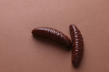Chocolate candies on brown background. Top view