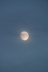 Full Moon Shines Through Ethereal Blue Clouds