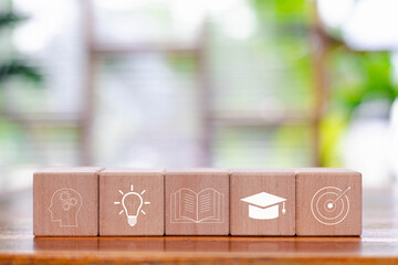 Wooden blocks with education icons representing creativity, knowledge, learning process, academic growth, goal achievement, symbolizing modern education, study motivation, lifelong learning concepts.