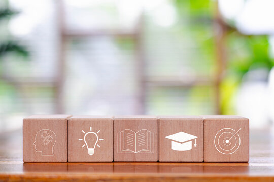 Wooden blocks with education icons representing creativity, knowledge, learning process, academic growth, goal achievement, symbolizing modern education, study motivation, lifelong learning concepts.