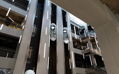 Modern glass capsule elevators in a shopping mall