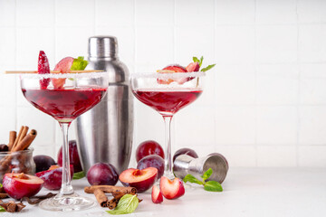Sugar plum autumn winter sweet tasty drink. Alcohol or non-alcohol cocktail, mocktail with plum syrup, hard liqueur, spices, cinnamon and mint, copy space