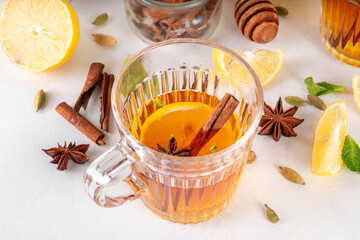 Hot Toddy winter autumn alcohol cocktail, traditional drink useful against flu, colds and coughs, with honey, lemon, and strong whiskey alcohol, spices, cinnamon and cloves