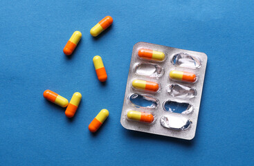 Blister of pills on blue background. Medicine concept