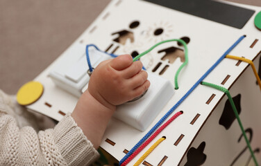 Wooden cube for developing motor skills of small children
