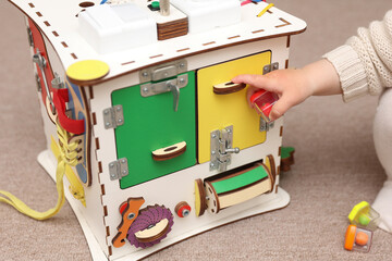 Wooden cube for developing motor skills of small children