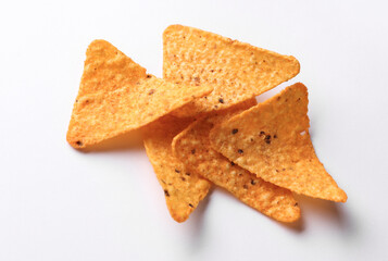Triangular appetizing corn tortilla chips slices on white background