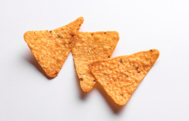 Triangular appetizing corn tortilla chips slices on white background