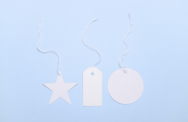 White blank different tags on string, blue background
