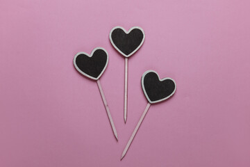 Chalkboard labels, blank wooden blackboard tags, heart shaped garden sign on pink background